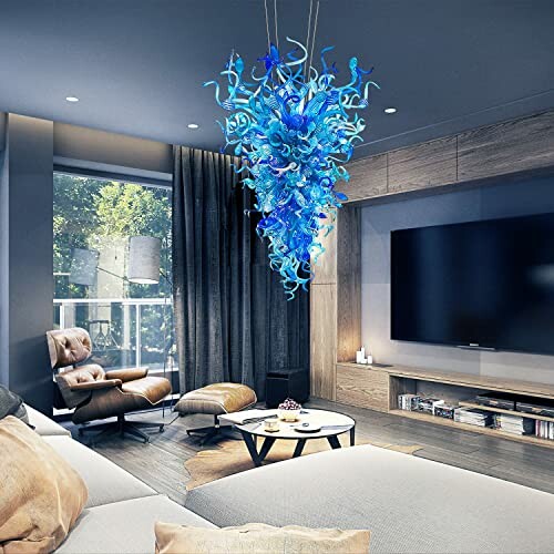A modern living room with a blue chandelier and a large TV.