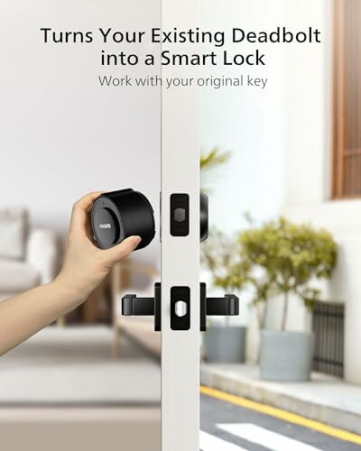 Hand installing a smart lock on a door