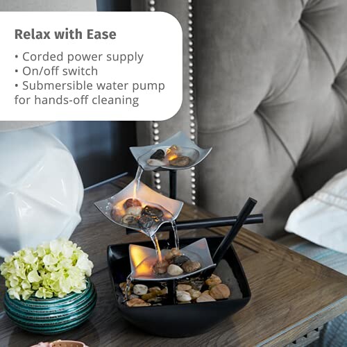 Tabletop water fountain with stones and LED lights on a bedside table